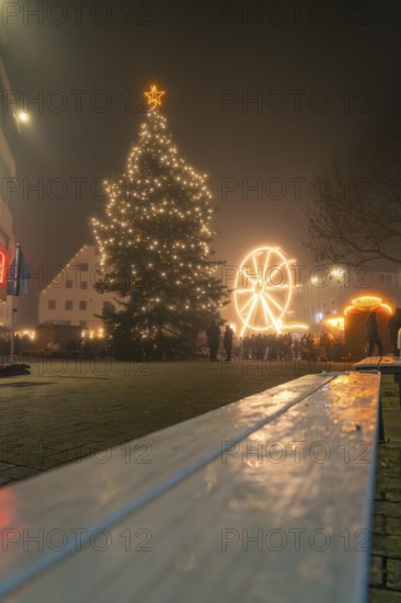 Festively illuminated Christmas market with illuminated tree and Ferris wheel at night, Christmas market 2025, Nagold, Black Forest, Calw district, Germany