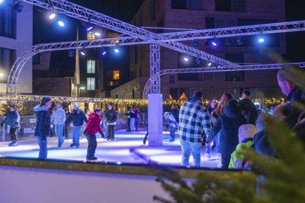 People skating on an illuminated area surrounded by a winter atmosphere, Christmas market 2025, Nagold, Black Forest, Calw district, Germany