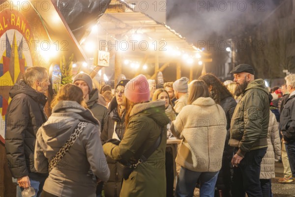 A group of people meet at a busy Christmas market, Christmas market 2025, Nagold, Black Forest, Calw district, Germany