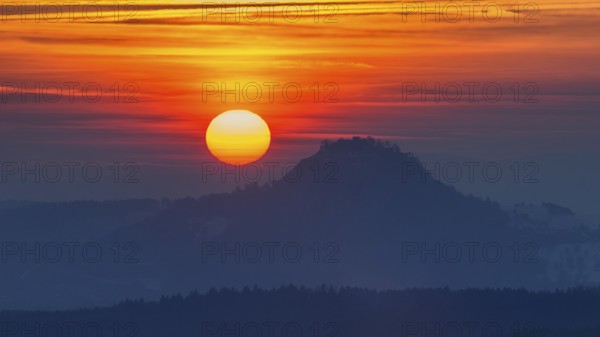 The distinctive silhouette of the Hohentwiel Hegau volcano at sunset, Konstanz district, Baden-WÃ¼rttemberg, Germany