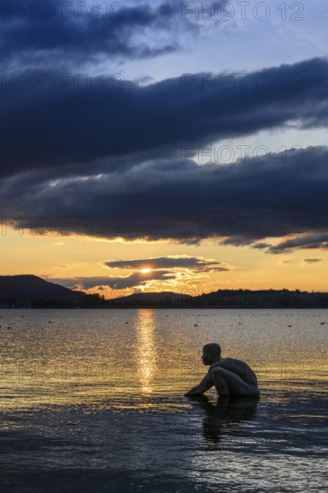 Bronze sculpture El NiÃ±o on the lakeside of Radolfzell am Lake Constance at sunset, Konstanz district, Baden-WÃ¼rttemberg, Germany