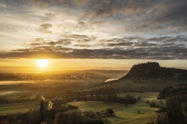 Sunrise with the Hohentwiel Hegau volcano, plumes of smoke from the burnt down historic bushel hall can be seen at the foot of the Hohentwiel, district of Constance, Baden-WÃ¼rttemberg, Germany