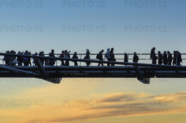Pedestrians, tourists cross the Millenium Bridge, which connects the City of London in the north to Southwark in the south, England, Great Britain