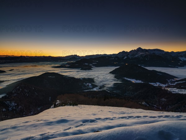 Alpine panorama at dawn in winter, fog in the valley, partly illuminated from below, Untersberg, Marktschellenberg, Berchtesgadener Land, Upper Bavaria, Bavaria, Germany