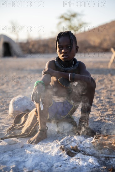 Himba child at the fire early in the morning, traditional Himba village, Kaokoveld, Kunene, Namibia