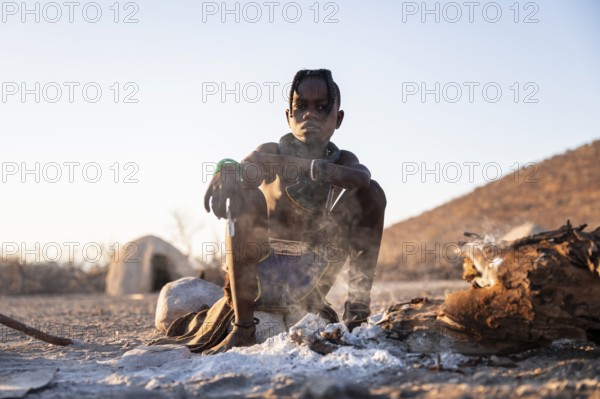 Himba child at the fire early in the morning, traditional Himba village, Kaokoveld, Kunene, Namibia