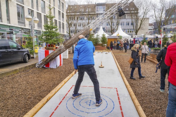 People playing curling on an open square in a wintry town, Sindelfingen, Böblingen district, Germany