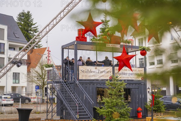 A stage with musicians and Christmas decorations in an urban environment, Sindelfingen, Böblingen district, Germany