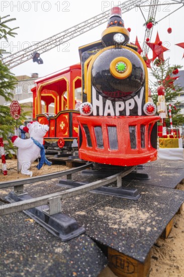 Red toy train with cheerful decoration on rails in a festive setting, Sindelfingen, Böblingen district, Germany