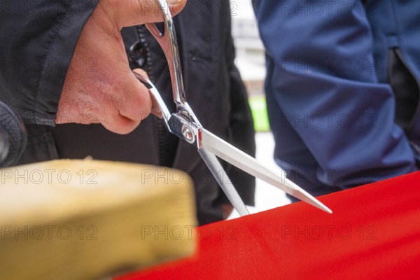 Close-up of scissors cutting a red ribbon at an opening ceremony, Sindelfingen, Böblingen district, Germany