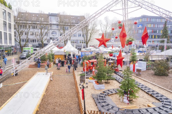 Christmas market with decorations and a toy train surrounded by visitors, Sindelfingen, Böblingen district, Germany