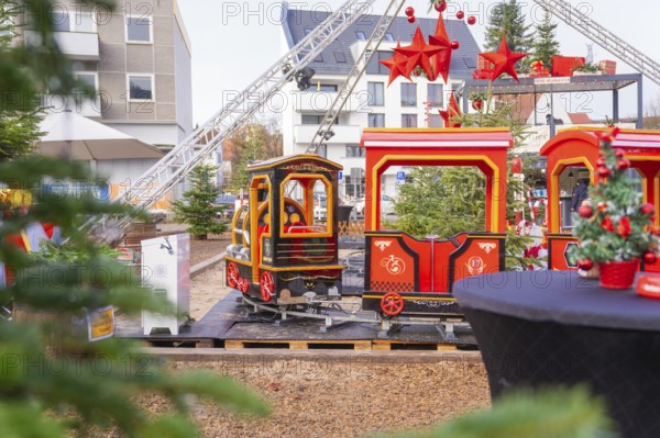 A brightly decorated miniature train with red stars in a festive city setting, Sindelfingen, Böblingen district, Germany