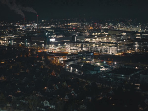 Industrial nocturnal cityscape with glowing buildings and factories, Sindelfingen, Böblingen district, Germany