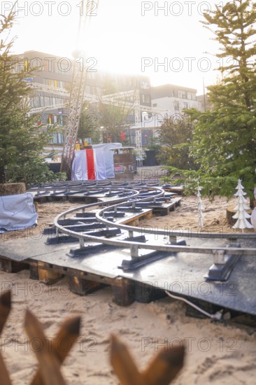 Curvy railroad tracks on Christmas market with sunlight in the background, Sindelfingen, Böblingen district, Germany