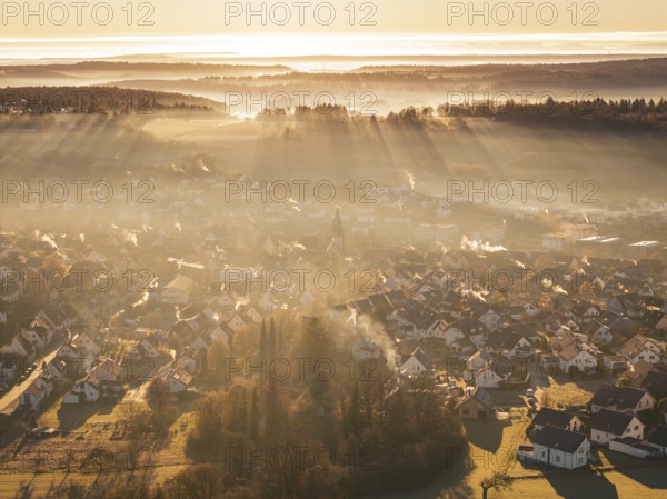 View of a village from above, rays of light and fog create an atmospheric atmosphere, Gechingen, Hecken and GÃ¤u region, Calw district, Germany