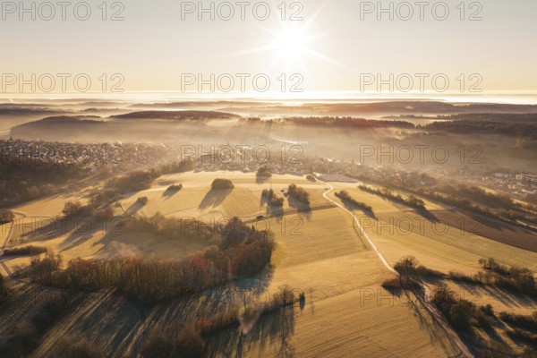 Aerial view of vast fields with bright sunshine and fog, Gechingen, Hecken and GÃ¤u region, Calw district, Germany