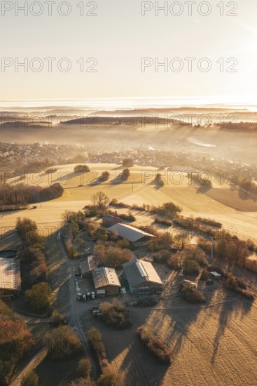 Fields and farm in a slightly foggy, hilly landscape under morning light, Gechingen, Hecken and GÃ¤u region, Calw district, Germany