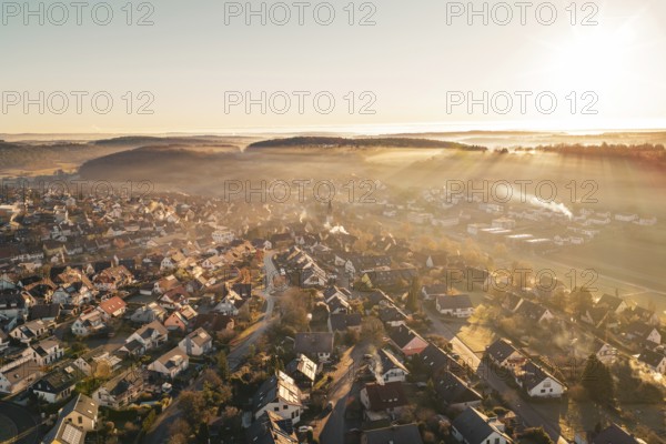 Sunrise over a village bathed in golden twilight shades, Gechingen, Hecken and GÃ¤u region, Calw district, Germany