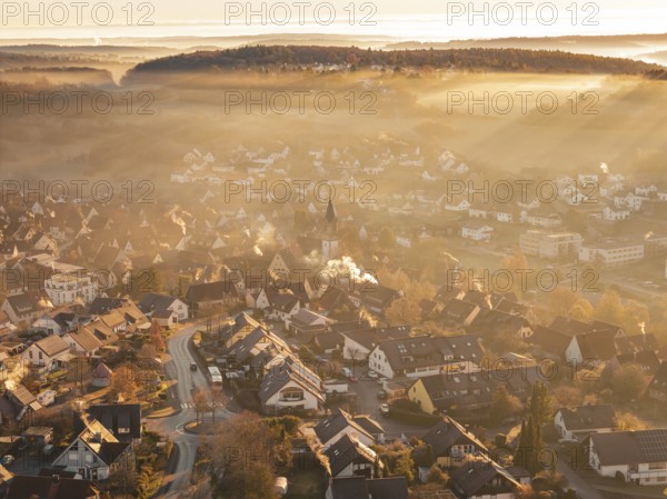 Fog-covered village with church tower in morning light with surrounding hills and mountains, Gechingen, Hecken and GÃ¤u region, Calw district, Germany