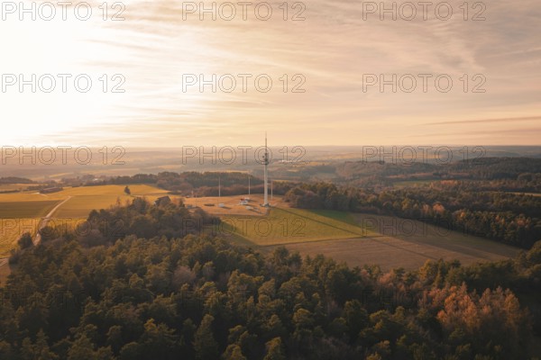 A radio tower rises in a vast landscape with forests and fields at sunset, Gechingen, Hecken and GÃ¤u region, Calw district, Germany