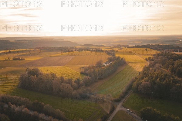 Extensive fields in soft sunset light with views of distant hills, Gechingen, Hecken and GÃ¤u region, Calw district, Germany