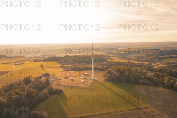 Single radio tower in an open field surrounded by forests in the evening light, Gechingen, Hecken and GÃ¤u region, Calw district, Germany