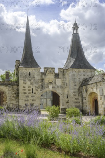 Lavender and double tower behind it with entrance gate at the Abbey of, Le Bec-Hellouin, Eure, France