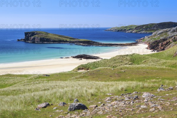 Dunes covered with beach oats line the idyllic sandy beach of Oldshoremore on the west coast of Scotland