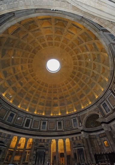 Isolated raindrops in the picture as white dots fall due to rotons in coffered ceiling with intersecting ribs beams of Pantheon di of Agripppa, Catholic church since 609 AD Basilica of Santa Maria ad Martyres, Rome, Lazio, Italy