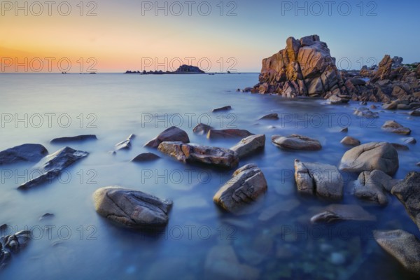 Distinctive orange rock formations in the evening light, on the English Channel coast on the Rosa Granti coast in Brittany, Pors Scaff, CÃ´tes-d'Armor in France