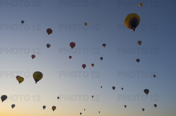 Many hot air balloons float in the morning sky and create a calm and adventurous atmosphere, Göreme Tarihî Millî ParkÄ±, Nevsehir Province, NevÅŸehir, Cappadocia, Capadocia, Cappadocia, Central Anatolia, Turkey