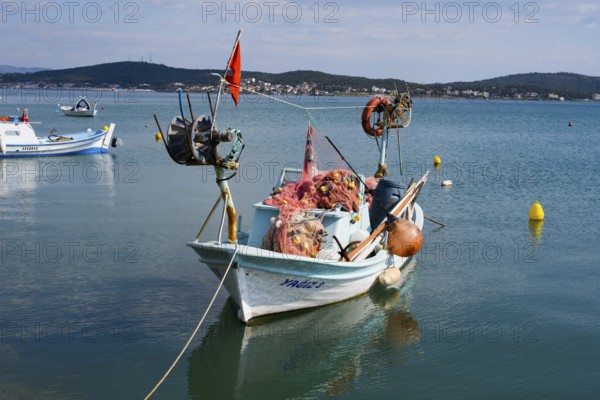 A fishing boat full of nets and equipment floats quietly on the water, Alibey, Alibey AdasÄ± Island, Cunda AdasÄ±, Ayvalik Islands, Ayvalik, Aegean Sea, Turkey
