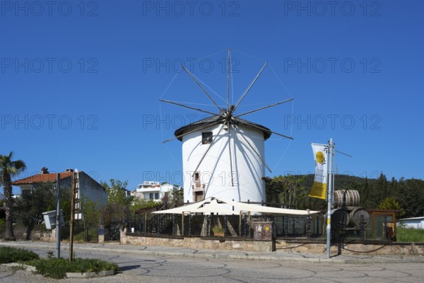 A traditional white windmill with wheels stands under bright blue sky, Cunda windmill, Alibey AdasÄ± Island, Cunda AdasÄ±, Ayvalik Islands, Ayvalik, Aegean Sea, Turkey
