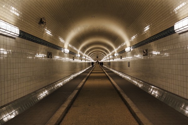 Pedestrians in the historic tunnel tube, Old Elbe Tunnel, symmetrically illuminated, tiled, Sankt Pauli, Hamburg, Germany