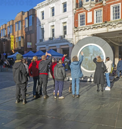 People on the Cornhill in the town centre view the first ever UK Portal in Ipswich, Suffolk, England, UK
