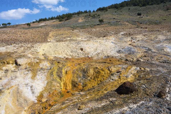 Geological landscape with hills and earthy tones under a partly cloudy blue sky, geothermal area, rainbow rocks Tuzla, AyvacÄ±k, Ayvacik, Ã‡anakkale, Canakkale, Turkey