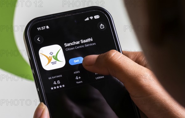 In this photo illustration, a person downloads the Sanchar Saathi mobile application on an iPhone, in New Delhi, India on 3 December 2025. Sanchar Saathi is officially developed and operated by the Department of Telecommunications (DoT), Government of India as part of its citizen-protection and telecom-security initiative