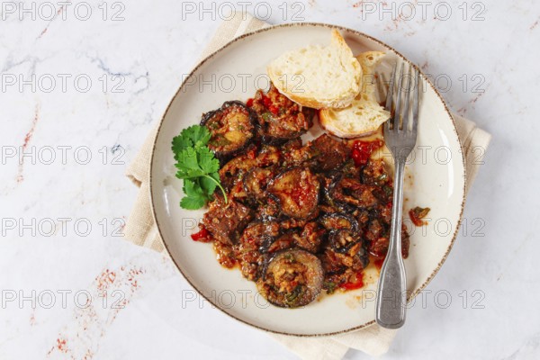 Stewed meat with eggplant is a Georgian dish, on a light background, homemade, no people