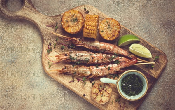 Langoustines on skewers, shrimp kebab, with fried corn, spices and herbs, homemade, no people