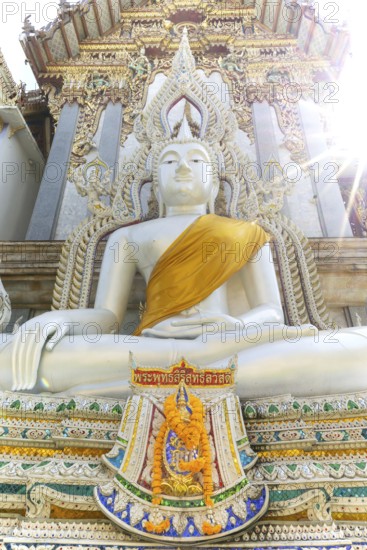Buddha statue with tunic, Bhumispara mudra, Buddha Gautama at the moment of enlightenment, at the entrance to Wat Sitthawararam, Bangkok, Thailand