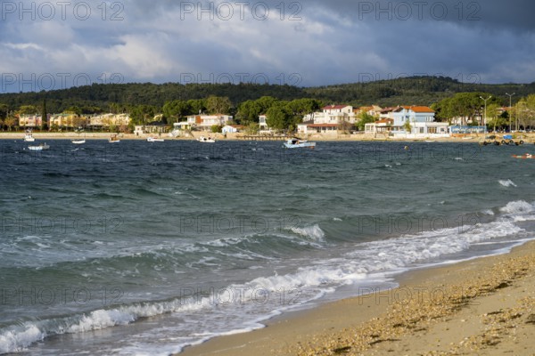 View of coast with soft waves, houses and cloudy sky, beach near GÃ¼zelyali, GÃ¼zelyalÄ±, Ã‡anakkale, Canakkale, Marmara region, Turkey