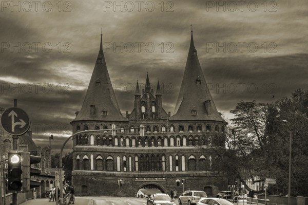 Holstentor, historic city gate from 1478, in the evening, sepia, Holstentorplatz, Hanseatic City of LÃ¼beck, Schleswig-Holstein, Germany