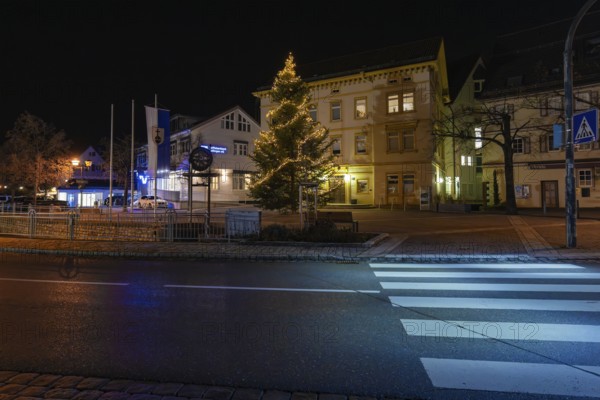 A festively lit Christmas tree on a side of the street at night, Aidlingen, Böblingen district, Germany