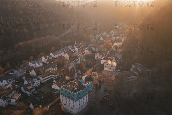 Panoramic picture of a village in front of a dense forest in the soft light of sunset, Dillweisenstein, Pforzheim, Germany