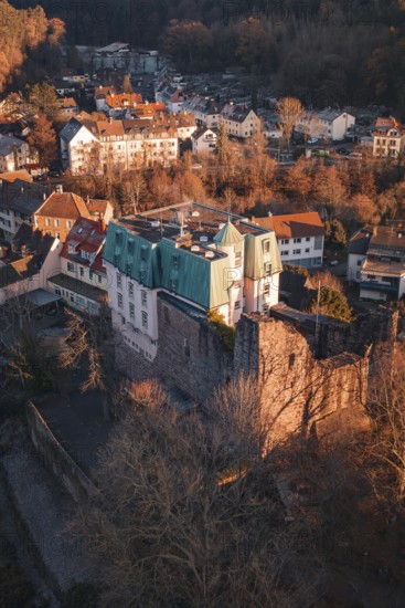 Picture of a castle and village in warm light with a view of wooded hills, Dillweisenstein, Pforzheim, Germany
