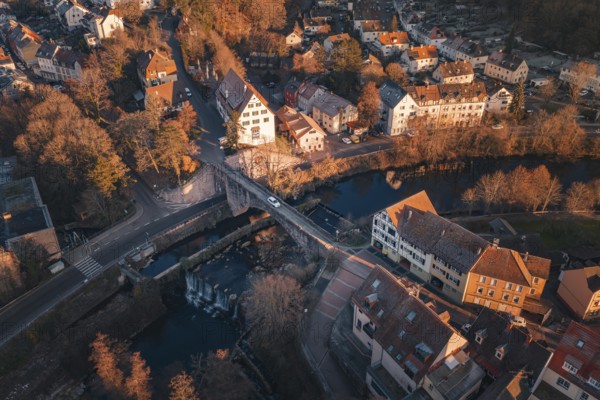 Aerial view of a picturesque village with river bridge and autumn colors, Dillweisenstein, Pforzheim, Germany