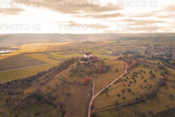 Church on hill with wide views of fields and villages under cloudy sky, Wurmlinger Chapel, Rottenburg am Neckar, Germany