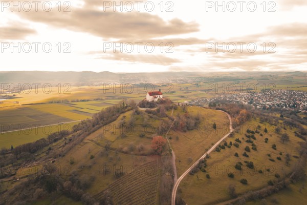 A church on a hill with a wide view of fields and villages under a cloud cover, Wurmlinger Chapel, Rottenburg am Neckar, Germany