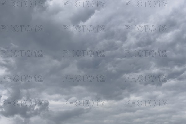 Grey cloud cover from Stratocumulus with bump-like bulges at the bottom unevenly marked by dents, international