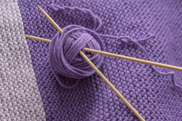 Close-up purple knitting with balls of wool and needles, North Rhine-Westphalia, Germany